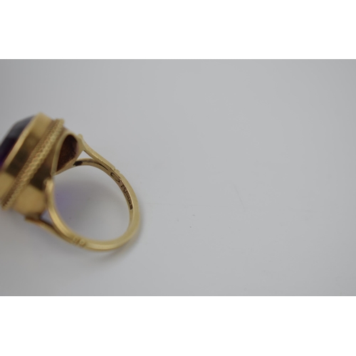 264 - 9ct gold ring set with circular purple stone, 5.2 grams, size M.