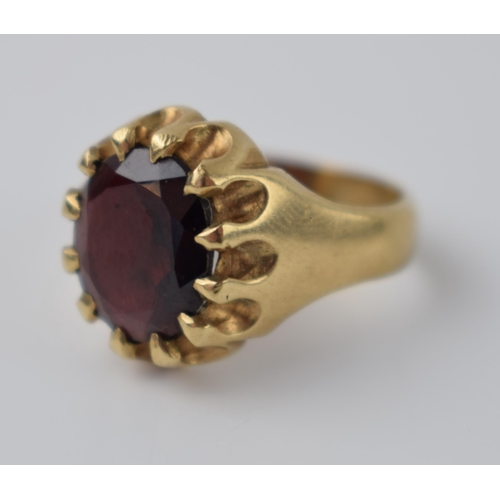 265 - 9ct gold gentlemans ring set with large faceted garnet, 6.9 grams, size P.