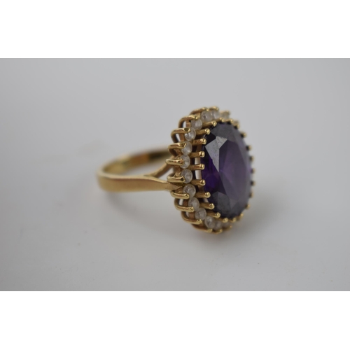 267 - 9ct gold ring set with CZs and a large amethyst style stone, 9.7 grams, size Q.