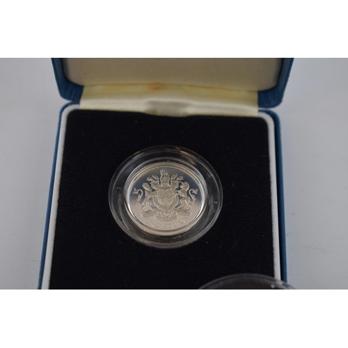 27 - A collection of silver proof coins to include boxed 1983 Royal Mint £1 coin, The Legend of St George... 