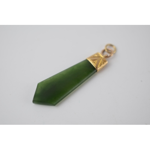 284 - 9ct gold and spinach jade pendant / charm 38cm long including ring.  Marked 9ct.