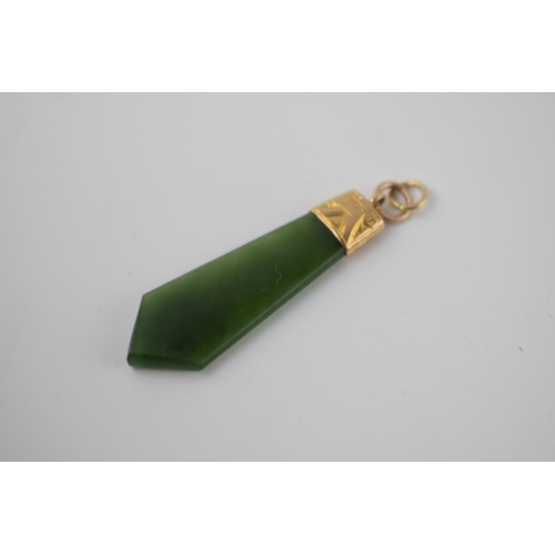 284 - 9ct gold and spinach jade pendant / charm 38cm long including ring.  Marked 9ct.