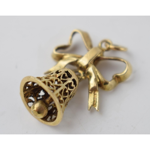 290 - 9ct gold charm in the form a bell hanging from a ribbon, 4.3 grams.