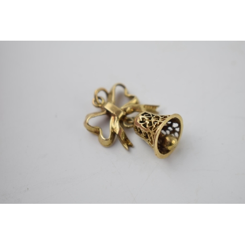 290 - 9ct gold charm in the form a bell hanging from a ribbon, 4.3 grams.