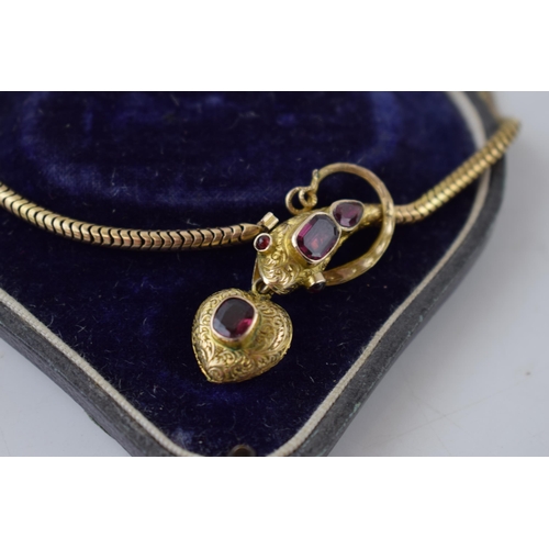 320 - Victorian gold snake mourning necklace, set with garnets, 22.6 grams, in fitted case.