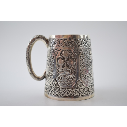 44 - Early 20th century Indian silver tankard with heavily embossed decoration, with exotic animals, 173.... 