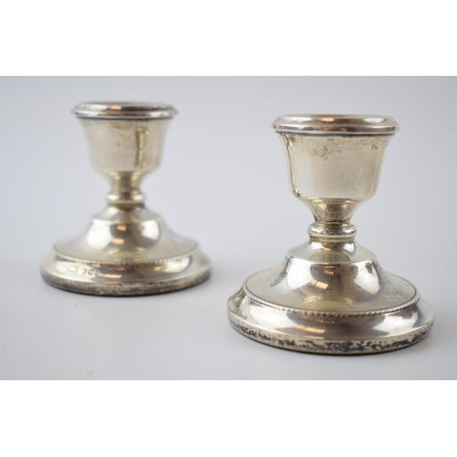 51 - Hallmarked silver candlesticks, Sheffield, 'ATC', loaded bases, 7cm tall (2).