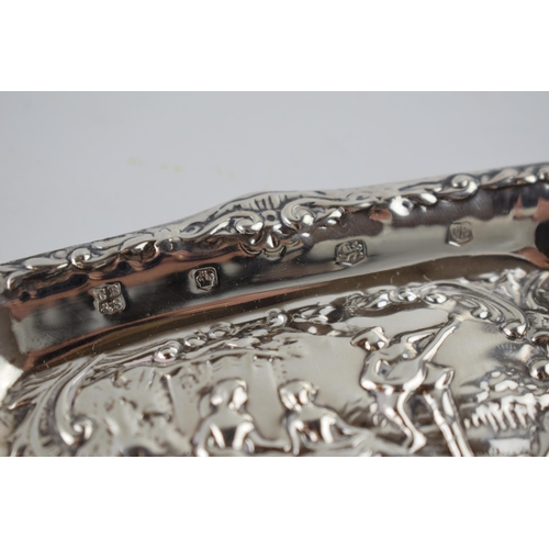 54 - Hallmarked silver heavily embossed pin tray with a romantical scene of a gentleman playing music for... 