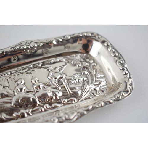 54 - Hallmarked silver heavily embossed pin tray with a romantical scene of a gentleman playing music for... 