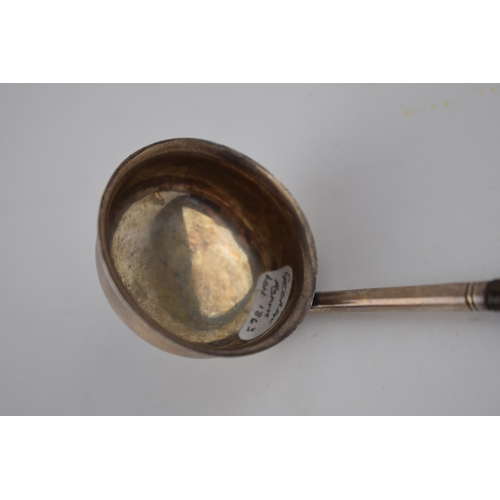 73 - Victorian silver toddy ladle with ebonised wooden handle, George Adams London 1863, 18cm long.