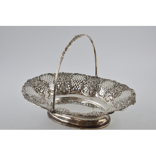 80 - Hallmarked silver large basket with swingover handle and pierced decoration, with foliage decoration... 