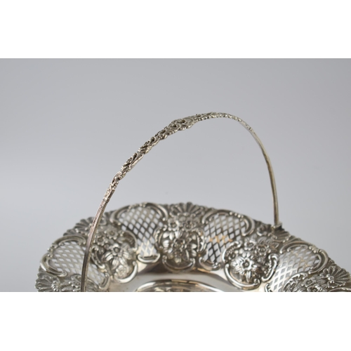 80 - Hallmarked silver large basket with swingover handle and pierced decoration, with foliage decoration... 