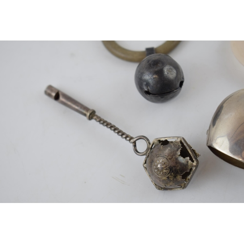 140 - A trio of silver baby rattles, one hallmarked Birmingham 1917 and another with a whistle (3)