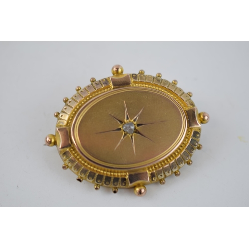 349 - Victorian gold target brooch with central diamond and bauble edge, mourning glazed panel to reverse,... 