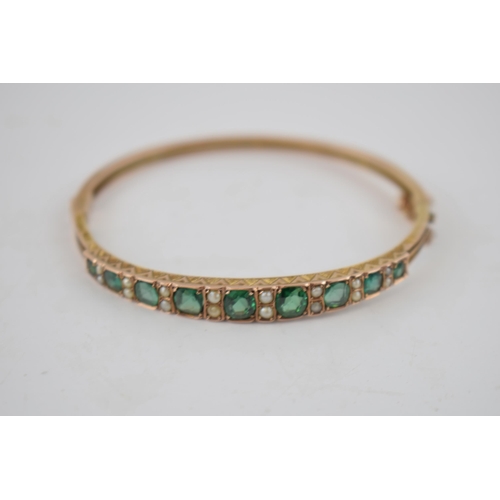 356 - Victorian 9ct gold green tourmaline and pearl bangle, Birmingham 1895, with safety chain, 8.7 grams.