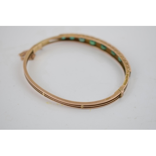 356 - Victorian 9ct gold green tourmaline and pearl bangle, Birmingham 1895, with safety chain, 8.7 grams.