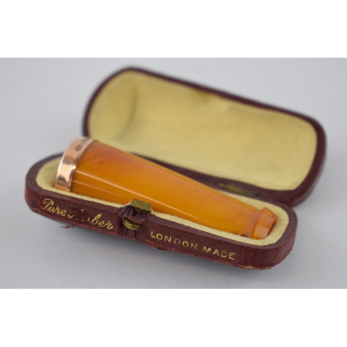 359 - Cased amber cigar holder with 9ct gold band, 5.5cm long.