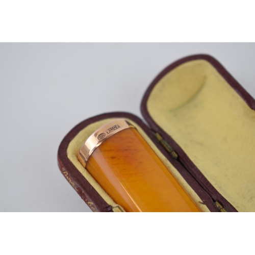 359 - Cased amber cigar holder with 9ct gold band, 5.5cm long.