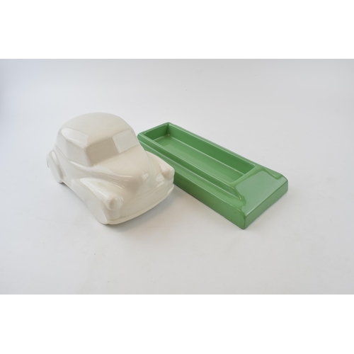 134 - Ceramic desk tidy in the form of a Morris Minor car. Green base with a cream car. Length 27cm, heigh... 