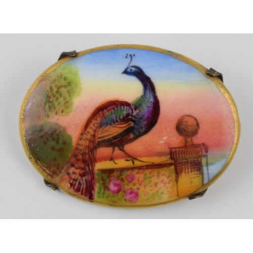 135 - Hand painted porcelain miniature brooch depicting a peacock standing on a wall at sunset. Possibly M... 