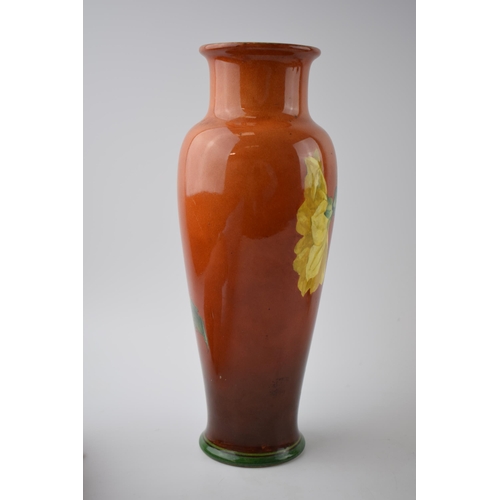 158 - Doulton Lambeth Faience high-shouldered vase decorated with Daffodils on red / deep orange backgroun... 