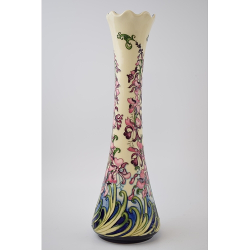 119 - Moorcroft Pottery tall vase, decorated with a floral scene, 16/50 made, red dot, 32.5cm tall.