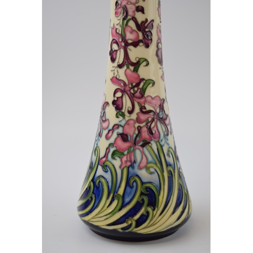 119 - Moorcroft Pottery tall vase, decorated with a floral scene, 16/50 made, red dot, 32.5cm tall.