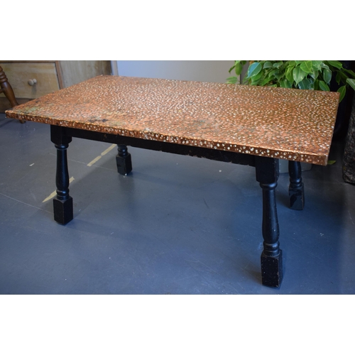 499 - A low pub style table with hand-hammered copper top. 87cm x 45cm. Height 39cm.