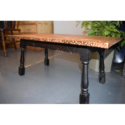 499 - A low pub style table with hand-hammered copper top. 87cm x 45cm. Height 39cm.