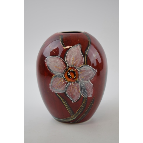 75 - Anita Harris Art Pottery trial vase, decorated with daffodils, 16cm tall, signed by Anita.