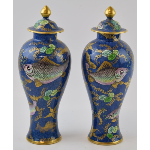 132 - A pair of New Chelsea Staffs lidded urns with fish decor and gilded decoration, 26cm tall (2 - 1 af)... 