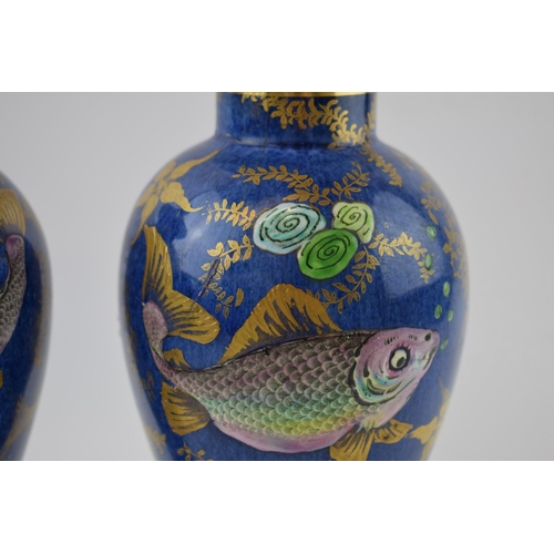 132 - A pair of New Chelsea Staffs lidded urns with fish decor and gilded decoration, 26cm tall (2 - 1 af)... 