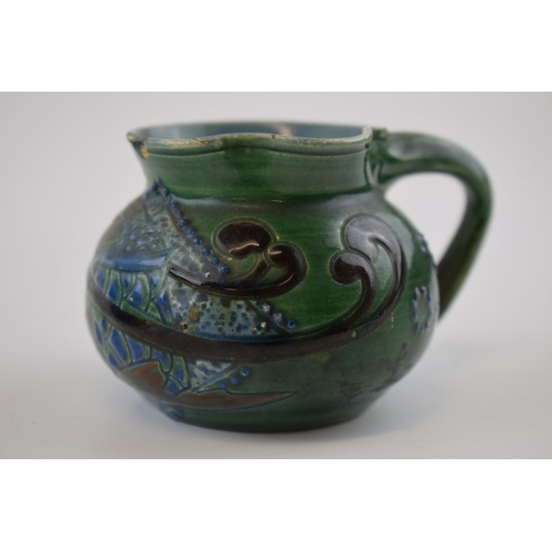 132A - C H Brannam pottery jug in the form of a fish, Arts and Crafts style (af to rim), 10cm wide.