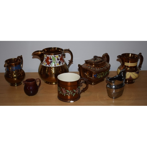 132H - A collection of early 19th century copper lustre items to include a large floral jug, a teapot, a sm... 