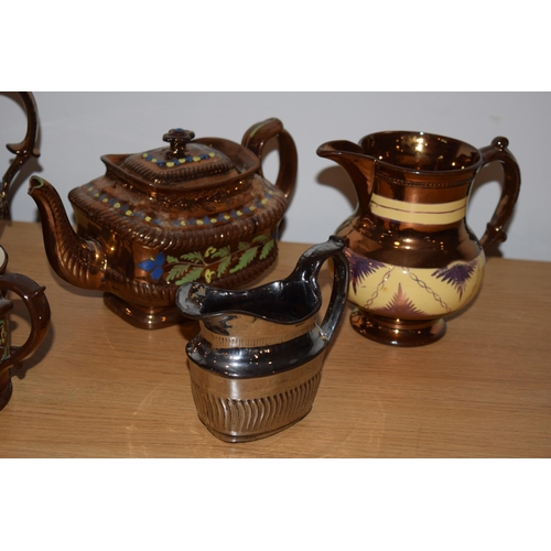 132H - A collection of early 19th century copper lustre items to include a large floral jug, a teapot, a sm... 