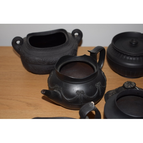 132I - A collection of 18th and 19th century Black Basalt pottery to include makes such as Wedgwood and Jac... 