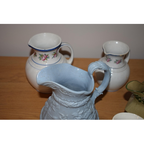 132L - An interesting collection of early 19th century moulded jugs to include a drab ware jug, a moulded h... 