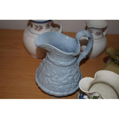 132L - An interesting collection of early 19th century moulded jugs to include a drab ware jug, a moulded h... 