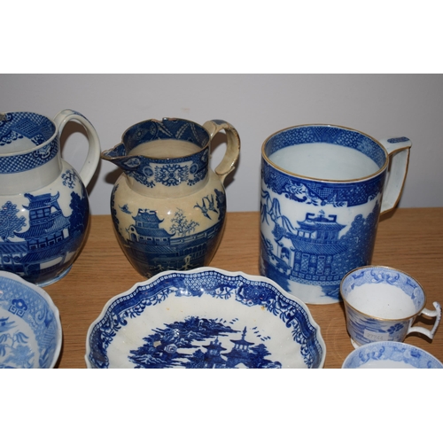 132O - A good collection of 19th century blue and white pottery to include pearlware jugs, bowls, tea bowls... 