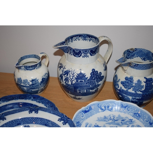 132O - A good collection of 19th century blue and white pottery to include pearlware jugs, bowls, tea bowls... 