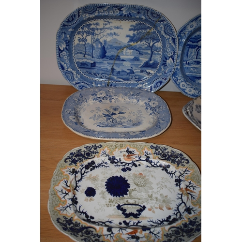 132R - A collection of 19th century large blue and white platters to include a castle scene, thought to be ... 