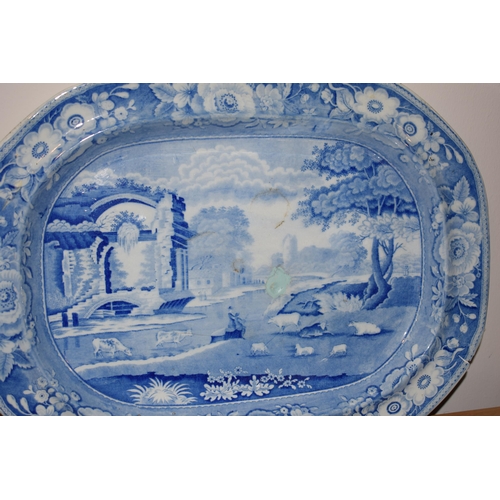 132R - A collection of 19th century large blue and white platters to include a castle scene, thought to be ... 