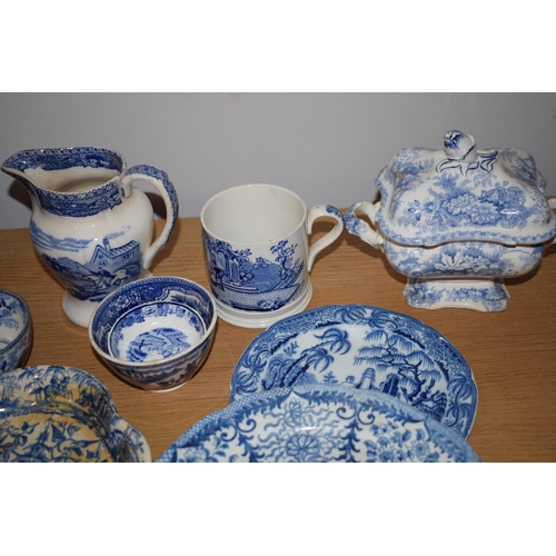 132S - 19th century blue and white pottery to include a Brameld Boys Fishing jar (missing lid), jugs, a tur... 