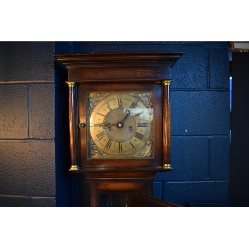 496 - Grandfather clock by Hampson of Wrexham, 1436. Brass dial with roman numerals. Oak case with brass f... 