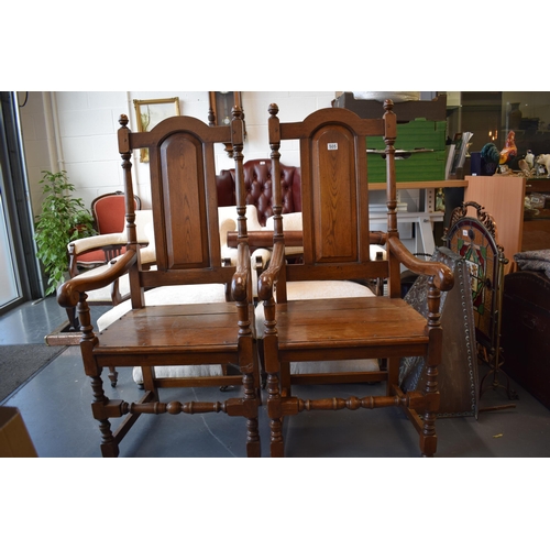 505 - A pair of oak Tudor style carver chairs. Pegged construction. Height 125cm, Width 57cm.