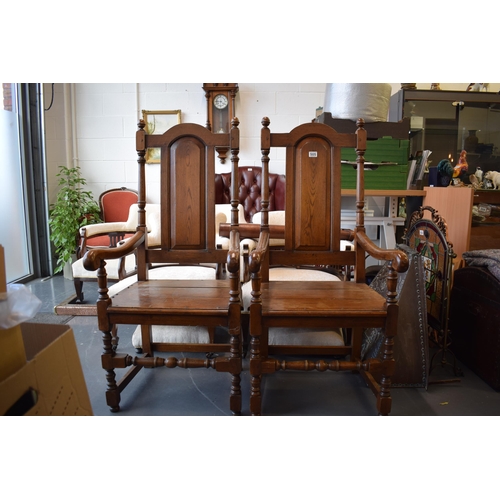 505 - A pair of oak Tudor style carver chairs. Pegged construction. Height 125cm, Width 57cm.