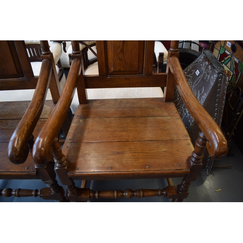 505 - A pair of oak Tudor style carver chairs. Pegged construction. Height 125cm, Width 57cm.