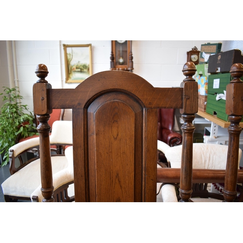 505 - A pair of oak Tudor style carver chairs. Pegged construction. Height 125cm, Width 57cm.