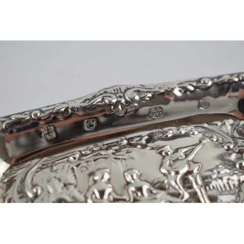 205 - Hallmarked silver heavily embossed pin tray with a romantical scene of a gentleman playing music for... 