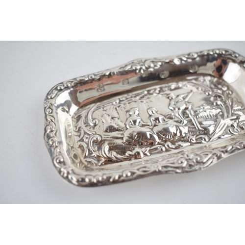 205 - Hallmarked silver heavily embossed pin tray with a romantical scene of a gentleman playing music for... 